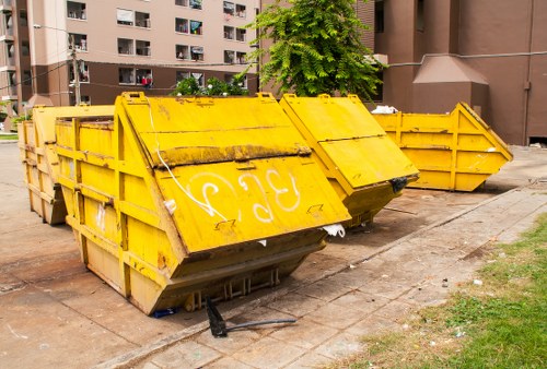 Construction workers managing waste on a building site in Anerley